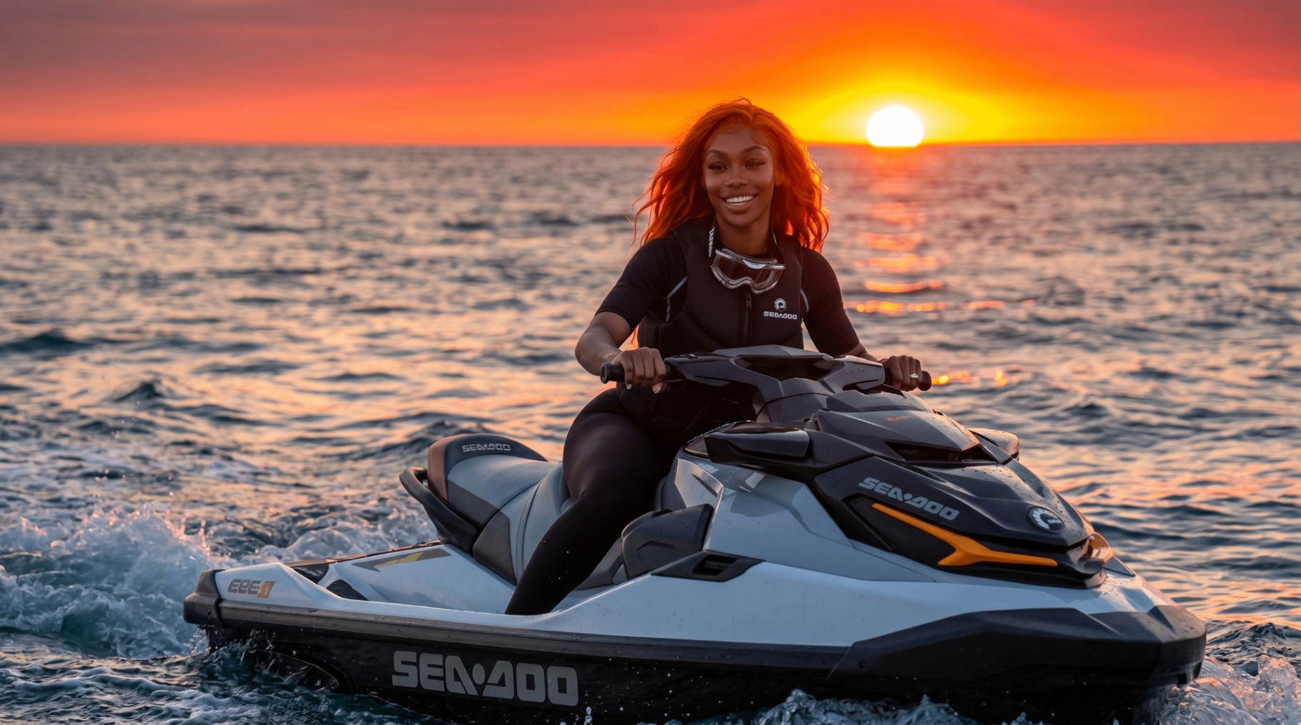 Jenna Smart riding a jet ski at sunset